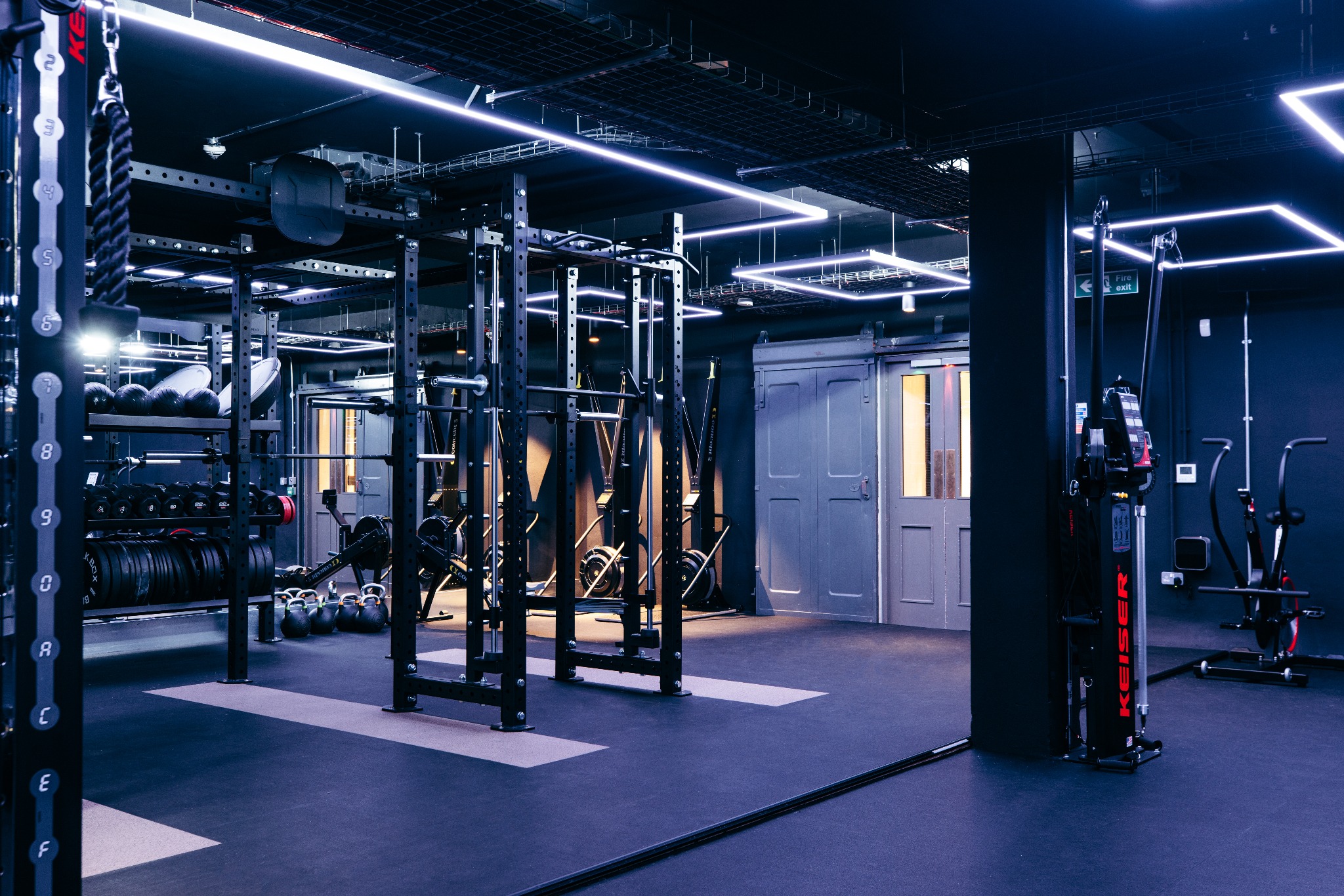 The Ministry gym with strength equipment, mirrored walls and geometric lighting